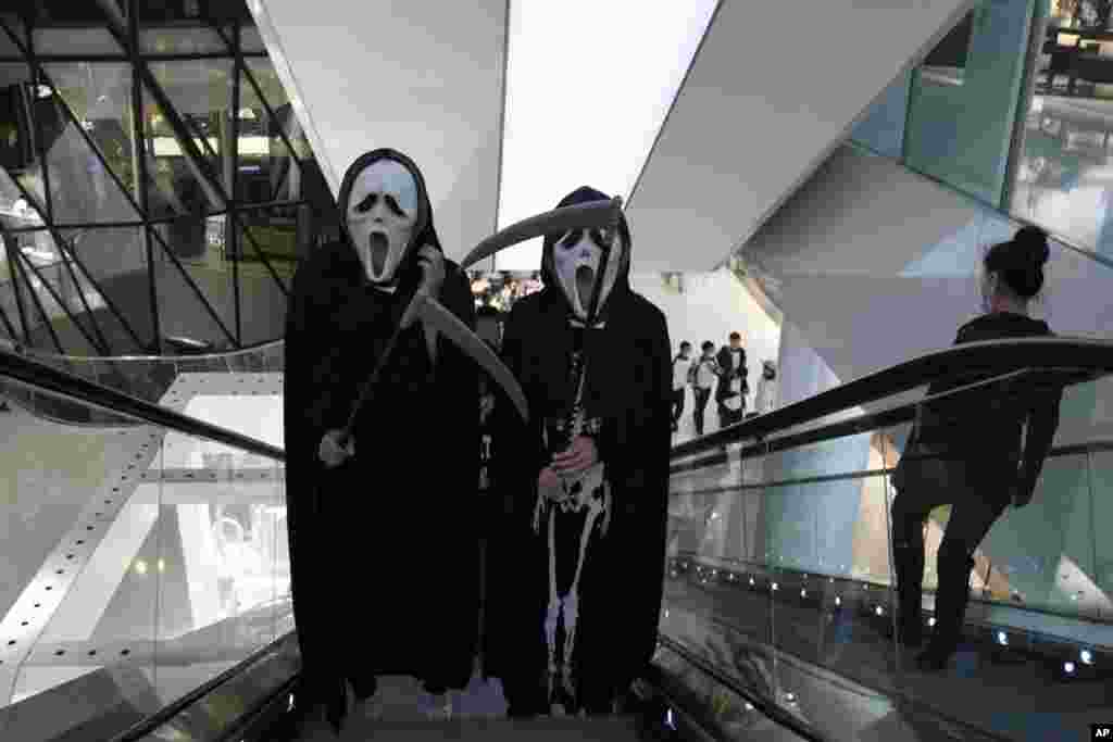 Workers dressed as ghouls try to raise spirits ahead of the Halloween festival at a shopping mall in Beijing on Friday, Oct. 30, 2020. Not traditionally celebrated in China, the Halloween festival is an excuse for attracting customers near the year end. (