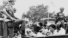 Members of the Youth Wing of the Indonesian Communist Party are guarded by soldiers as they are taken by an open truck to prison in Jakarta after they were rounded up by the army following a crackdown on communists after an attempted coup, Oct. 30, 1965.