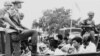 Members of the Youth Wing of the Indonesian Communist Party are guarded by soldiers as they are taken by an open truck to prison in Jakarta after they were rounded up by the army following a crackdown on communists after an attempted coup, Oct. 30, 1965.