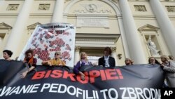 Protesters hold a map of Poland with 255 documented and alleged cases of sexual abuse of minors by the country's Catholic priests as they march in Warsaw, Poland, Oct. 7, 2018.