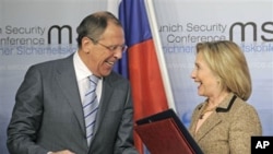 US Secretary of State Hillary Rodham Clinton, right, and Russia's Foreign Minister Sergey Lavrov smile after finalizing the New START treaty during the Conference on Security Policy in Munich, Germany, February 5, 2011