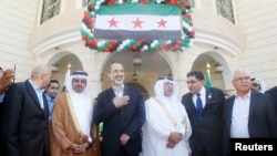 Syrian National Coalition leader Moaz Alkhatib (C) attends the opening of its embassy in Doha, Qatar, Mar. 27, 2013. 