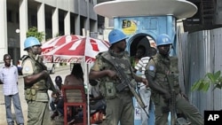 UN forces stand guard on a street in Abidjan, Ivory Coast, Dec 22, 2010
