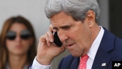 U.S. Secretary of State John Kerry speaks on a mobile phone after meeting with Israeli Prime Minister Benjamin Netanyahu in Tel Aviv, Israel, Nov. 8, 2013.