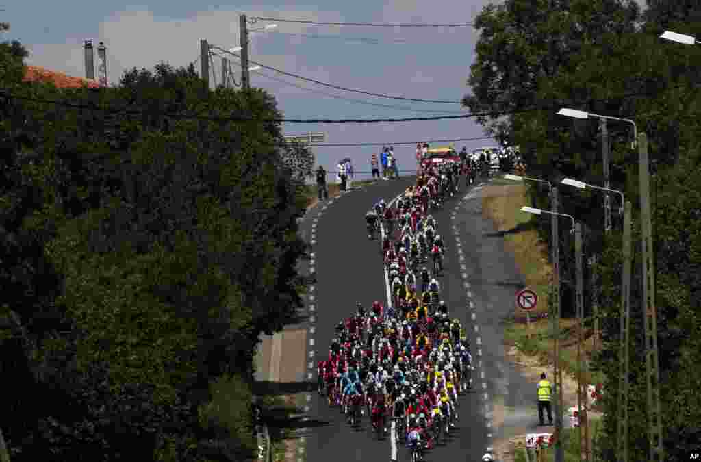 The pack cruises along during the fourth stage of the Tour de France cycling race over 207.5 kilometers (129 miles), with a start in Mondorf-les-Bains, Luxembourg, and a finish in Vittel, France.