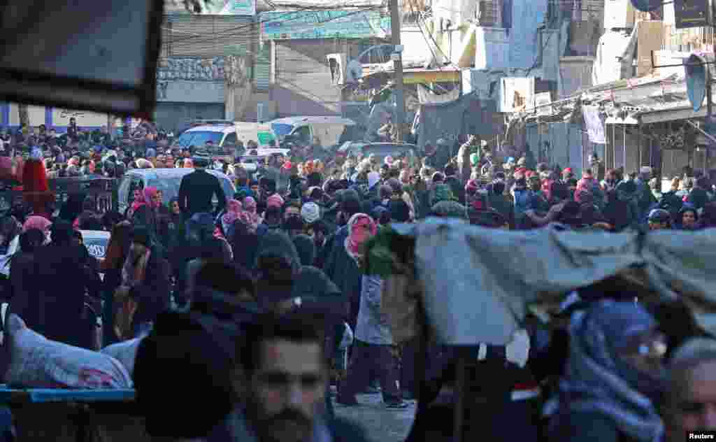 People gather to be evacuated from al-Sukkari rebel-held sector of eastern Aleppo, Syria, Dec. 15, 2016. 