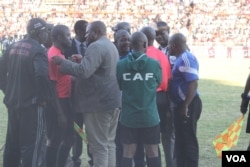 Highlanders acting chairman Modern Ngwenya pleads with second assistant referee Thomas Kusosa to return to the touchline after the match official was pelted with missiles.