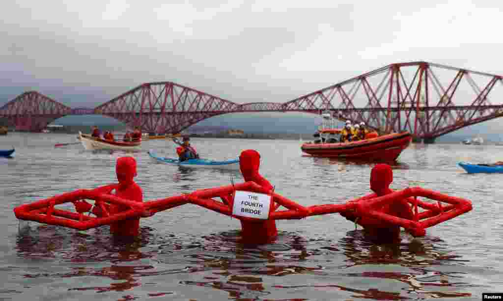 Swimmers participate in the New Year&#39;s Day Loony Dook swim at South Queensferry in Scotland, Britain.