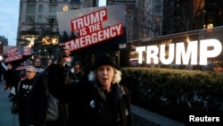 People gather to protest U.S. President Donald Trump's declaration of a national emergency to build a border wall, at Trump International Hotel & Tower in New York, Feb. 15, 2019.