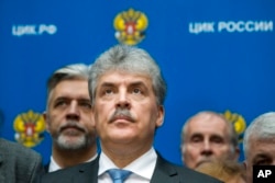 FILE - Pavel Grudinin, the Communist Party's candidate for the 2018 Russian presidential election, listens for a journalist's question after getting his candidate's ID at the Russia Central Election commission in Moscow, Russia, Jan. 12, 2018.