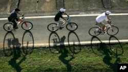 FILE - Cyclists cruise down a bike path in Taipei, Taiwan.