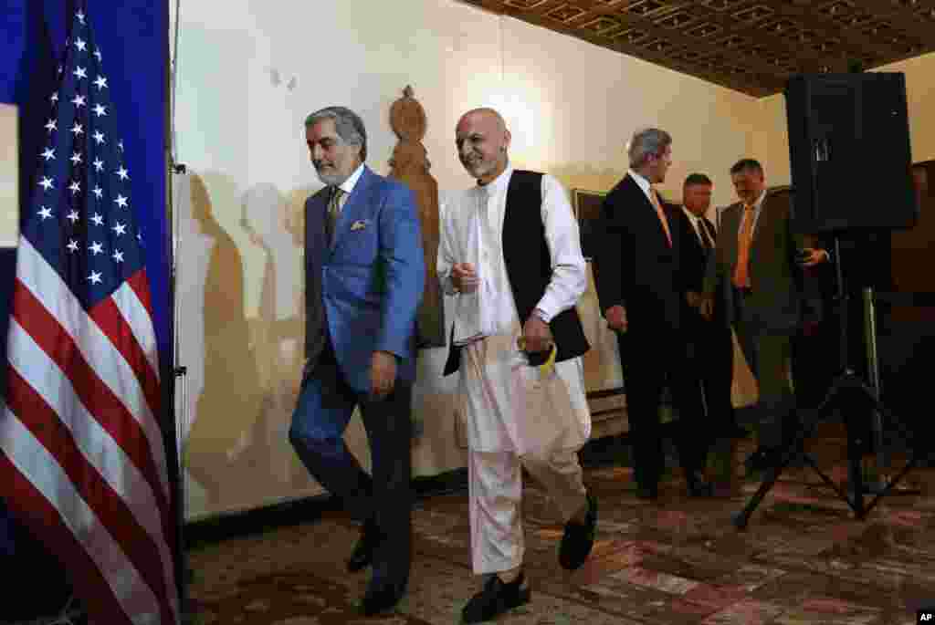 Afghan presidential candidates (from left) Abdullah Abdullah and Ashraf Ghani Ahmadzai (in white) and U.S. Secretary of State John Kerry (third from left) arrive at a joint press conference in Kabul, Afghanistan, Aug. 8, 2014.