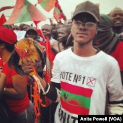 A young supporter of Angola's largest opposition party, UNITA, brought his chicken — which is also the party's mascot — to the party's final pre-vote rally in the capital, Luanda.