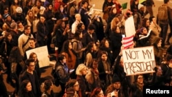 Protesters walk during a protest against Republican president-elect Donald Trump outside Trump International Hotel and Tower in Chicago, Illinois.