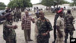 Somali military chief Gen. Dini, center, arrives at the scene of an explosion in Mogadishu, Nov. 30, 2011.
