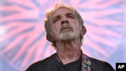FILE - Singer-songwriter J.J. Cale plays during the Eric Clapton Crossroads Guitar Festival in Dallas, Texas, June 5, 2004. 