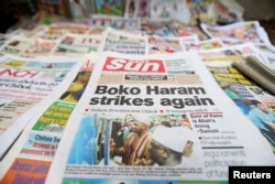 FILE - A newspaper with its front page headline on an abduction of women from a village in northeast Nigeria is displayed at a vendor's stand along a road in Ikoyi district in Lagos, Nigeria, June 10, 2014.