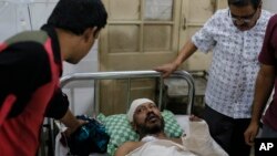 Injured writer Sudeep Kumar Ray Barman receives treatment at the Dhaka Medical College Hospital in Dhaka, Bangladesh, Saturday, Oct. 31, 2015.