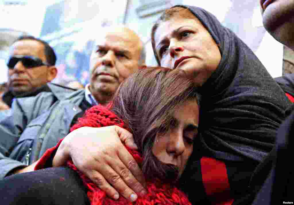 The mother (R) of photographer Nadhir Ktari, who disappeared with fellow journalist Sofiane Chourabi in Libya in September, attends a demonstration held in solidarity with the missing pair, in Tunis, Tunisia.