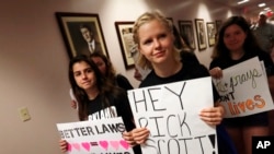 Student survivors from Marjory Stoneman Douglas High School walk through the halls of the state capitol to challenge lawmakers on gun control reform, in Tallahassee, Fla., Feb. 21, 2018.