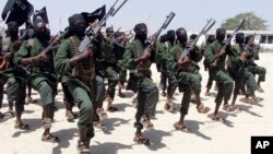 FILE - Hundreds of newly trained al-Shabab fighters perform military exercises in the Lafofe area, south of Mogadishu, Somalia.