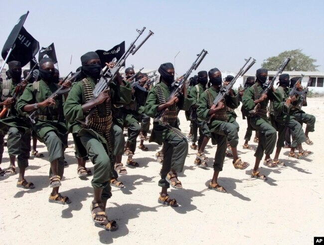 FILE - Hundreds of al-Shabab fighters perform military exercises in the Lafofe area, some 18 km south of Mogadishu, Somalia. Al-Shabab has been identified as both an internal threat to Somalia as well as an international threat due to its al-Qaida links.