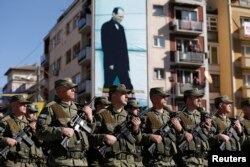 Members of Kosovo Security Forces march during a celebration marking the eighth anniversary of Kosovo's declaration of independence from Serbia, in Pristina, Feb. 17, 2016.