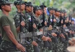 Karen National Union (KNU) soldiers hold their assault weapons as they parade during the celebration of the 63rd anniversary of the Karen Revolution day at Oo Kray Kee village in Karen State, near the Thai-Myanmar border on January 31, 2012. The KNU is w