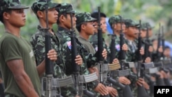 Karen National Union (KNU) soldiers hold their assault weapons as they parade during the celebration of the 63rd anniversary of the Karen Revolution day at Oo Kray Kee village in Karen State, near the Thai-Myanmar border on January 31, 2012. The KNU is w
