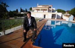 FILE - Vyacheslav Eshanu, head of PortugalEstate, poses at a house which is selling for two million euros in Portimao November 11, 2013. A shattering economic crisis later, Spain and Portugal are trying to resurrect their moribund property markets by offering "golden" residence permits to home buyers from outside the European Union.