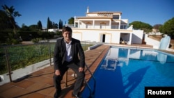 The head of PortugalEstate poses at a house. Portugal is offering "golden" residence permits to home buyers from outside the European Union.