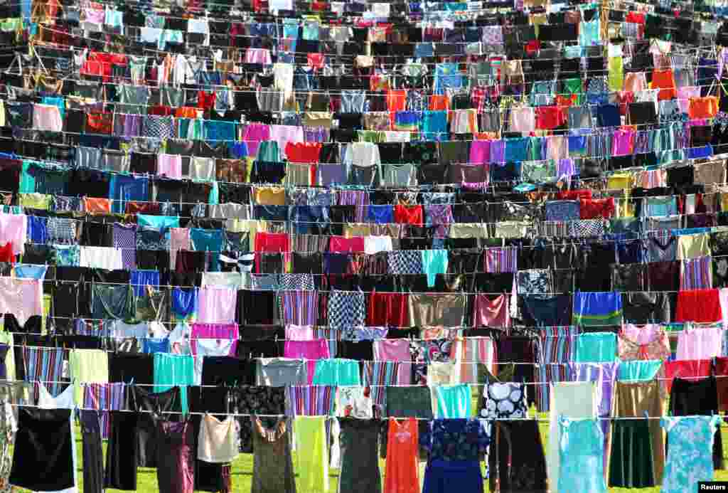 Dresses and skirts are seen hanging inside a stadium, in an art exhibition titled &quot;Thinking of You&quot; by Kosovo-born, London-based artist Alketa Xhafa-Mripa, in Pristina, Kosovo. Dresses and skirts donated by Cherie Blair and Rita Ora were among 5,000 pegged to washing lines in the stadium to draw attention to the stigma suffered by victims of wartime sexual violence.