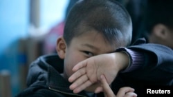 FILE - An autistic child attends a therapy session in Beijing, China, March 23, 2009. 