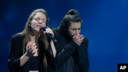 Salvador Sobral from Portugal, right, performs the song "Amar pelos dois" with his sister Luisa after winning the Final of the Eurovision Song Contest, in Kyiv, Ukraine, May 13, 2017. 