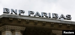 The logo of French bank BNP Paribas is seen above the facade of their central Paris agency June 30, 2014.