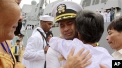 U.S. navy officer Michael "Vannak Khem" Misiewicz becomes emotional as he embraces his aunt Samrith Sokha, 72, at Cambodian coastal international sea port of Sihanoukville.