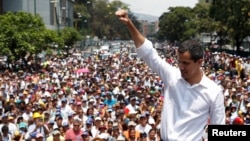 Venezuelan opposition leader Juan Guaido, whom many nations have recognized as the country's rightful interim ruler, gestures as he speaks to supporters during a rally against the government of President Nicolas Maduro and to commemorate May Day in Caracas, Venezuela.
