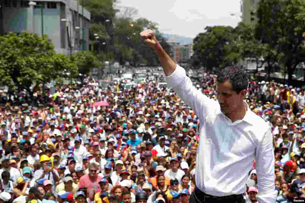 Venezuelan opposition leader Juan Guaido, whom many nations have recognized as the country's rightful interim ruler, gestures as he speaks to supporters during a rally against the government of President Nicolas Maduro and to commemorate May Day in Caraca