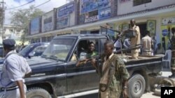 Somali security officials patrol near southern Mogadishu's K4 intersection conducting operations to ensure security, May 9, 2011