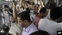 Egyptian man recites versus from the Quran at an underground metro after a massive power cut has hit large parts of Cairo, Egypt, August 9, 2012. 