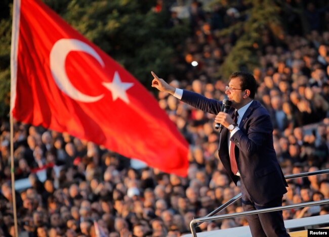 FILE - Newly elected Mayor of Istanbul Ekrem Imamoglu addresses his supporters outside the City Hall in Istanbul, Turkey, April 17, 2019.