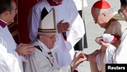 The Fisherman's Ring is placed on the finger of Pope Francis by Cardinal Angelo Sodano. (Mar. 19, 2013) 