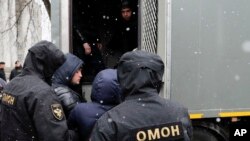 Belarus police detain an activist, center, prior to an opposition rally in Minsk, March 25, 2017.