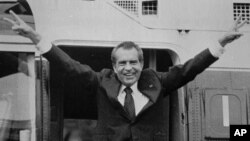 Richard Nixon says goodbye to members of his staff outside the White House as he boards a helicopter for Andrews Air Force Base after resigning the Presidency, August 9, 1974.