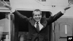 Richard Nixon says goodbye to members of his staff outside the White House as he boards a helicopter for Andrews Air Force Base after resigning the presidency on August 9, 1974.