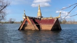 FILE - The roof of a small wooden temple juts out above the water line in Srekor village in Cambodia’s northeastern Stung Treng province, which has been affected by flooding caused by the Lower Sesan 2 Dam, Nov 28, 2018. (Sun Narin/VOA Khmer)