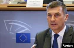 FILE - Andrus Ansip addresses the European Parliament's Committee on the Internal Market and Consumer Protection at the EU Parliament in Brussels, Oct. 6, 2014.