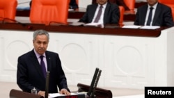 FILE - Turkey's Deputy Prime Minister Bulent Arinc addresses the Turkish Parliament in Ankara in a 2013 photo.