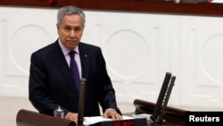 FILE - Turkey's Deputy Prime Minister Bulent Arinc addresses the Turkish Parliament in Ankara in a 2013 photo.