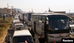 Civilians and rebel fighters are evacuated from the Wadi Barada valley after an agreement was reached between rebels and Syria's army, arrive riding buses in the rebel controlled Qalaat al-Madiq, Syria, Jan. 30, 2017.